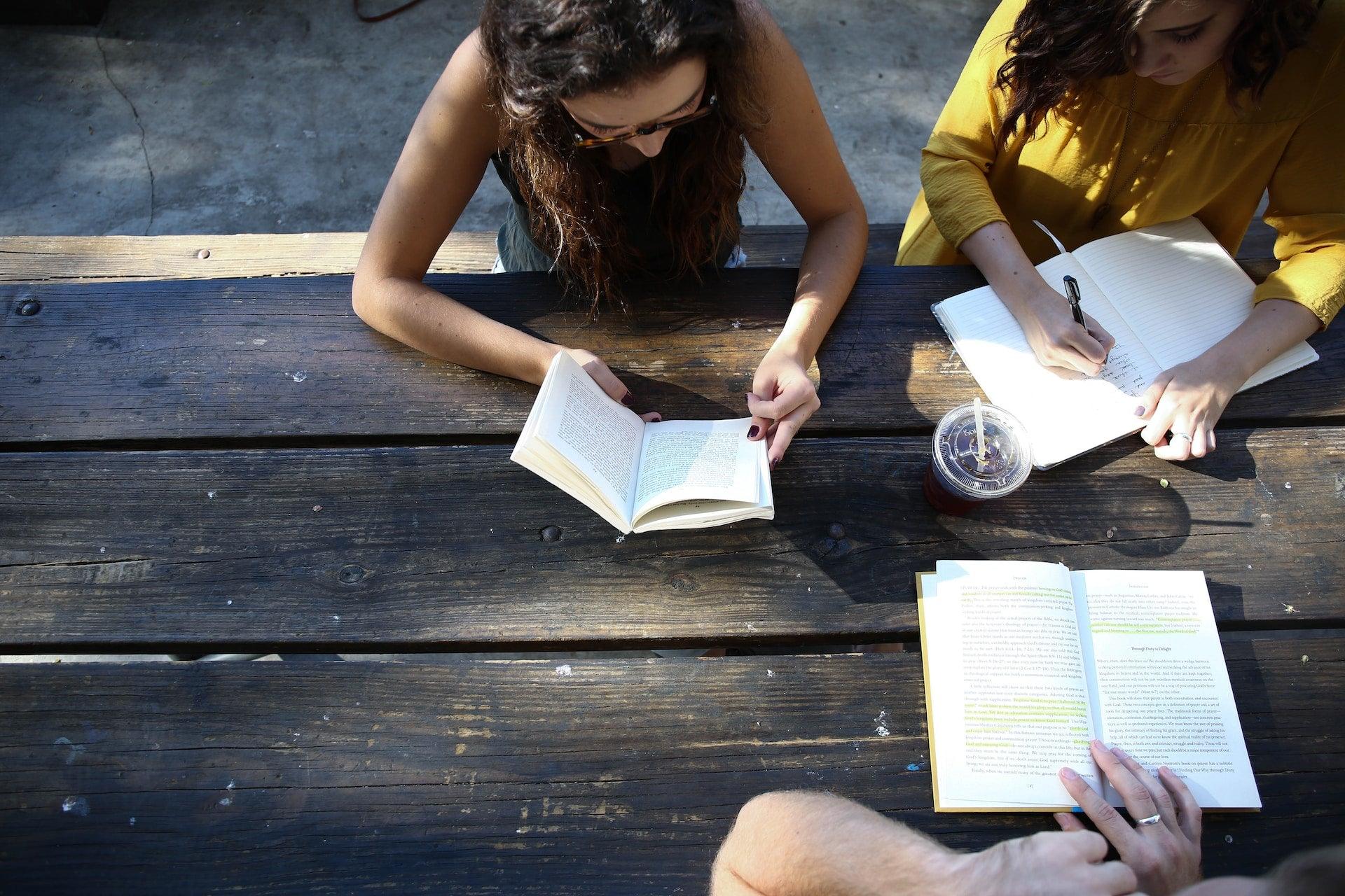 Women reading around a table