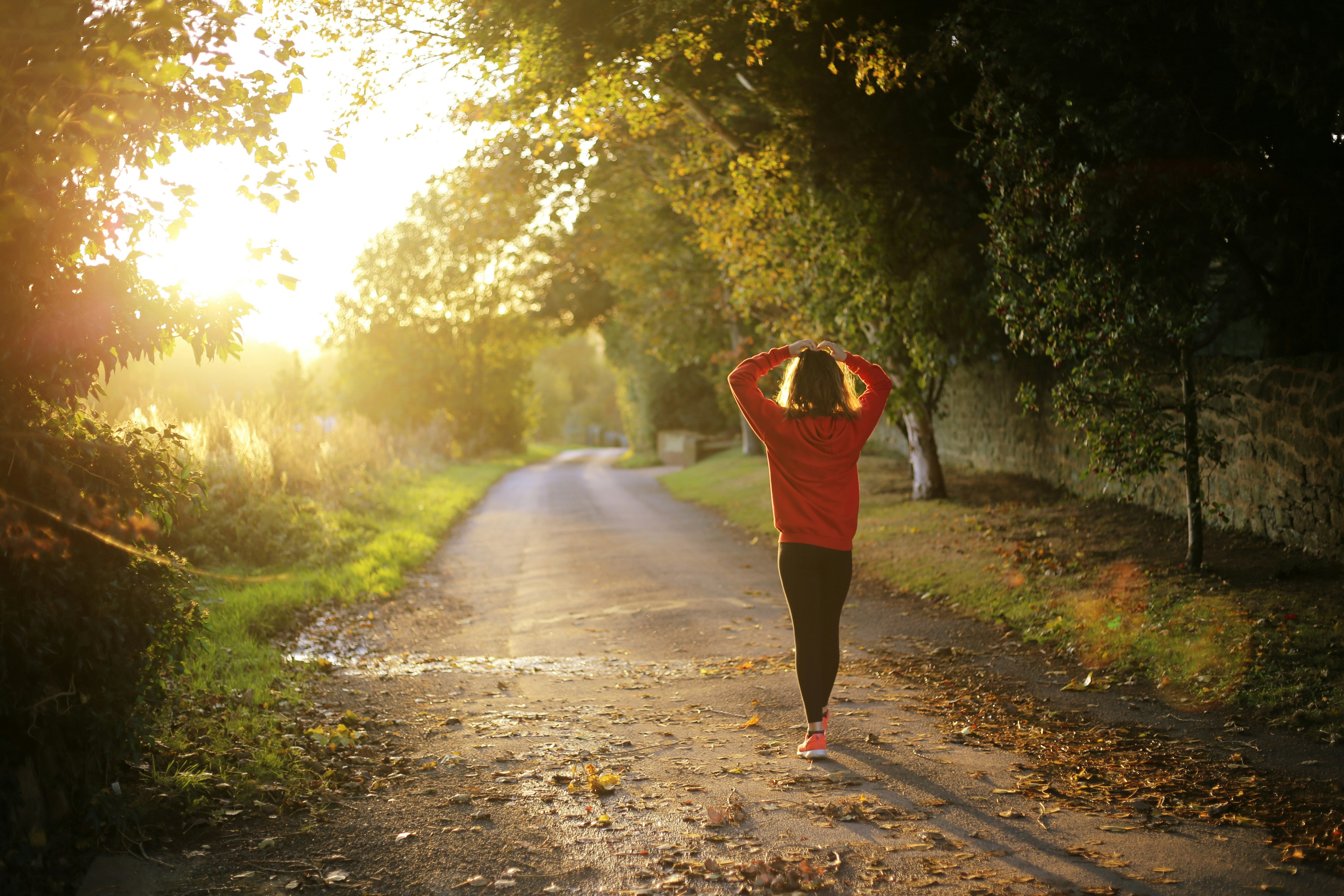 Lady going for golden hour walk in nature
