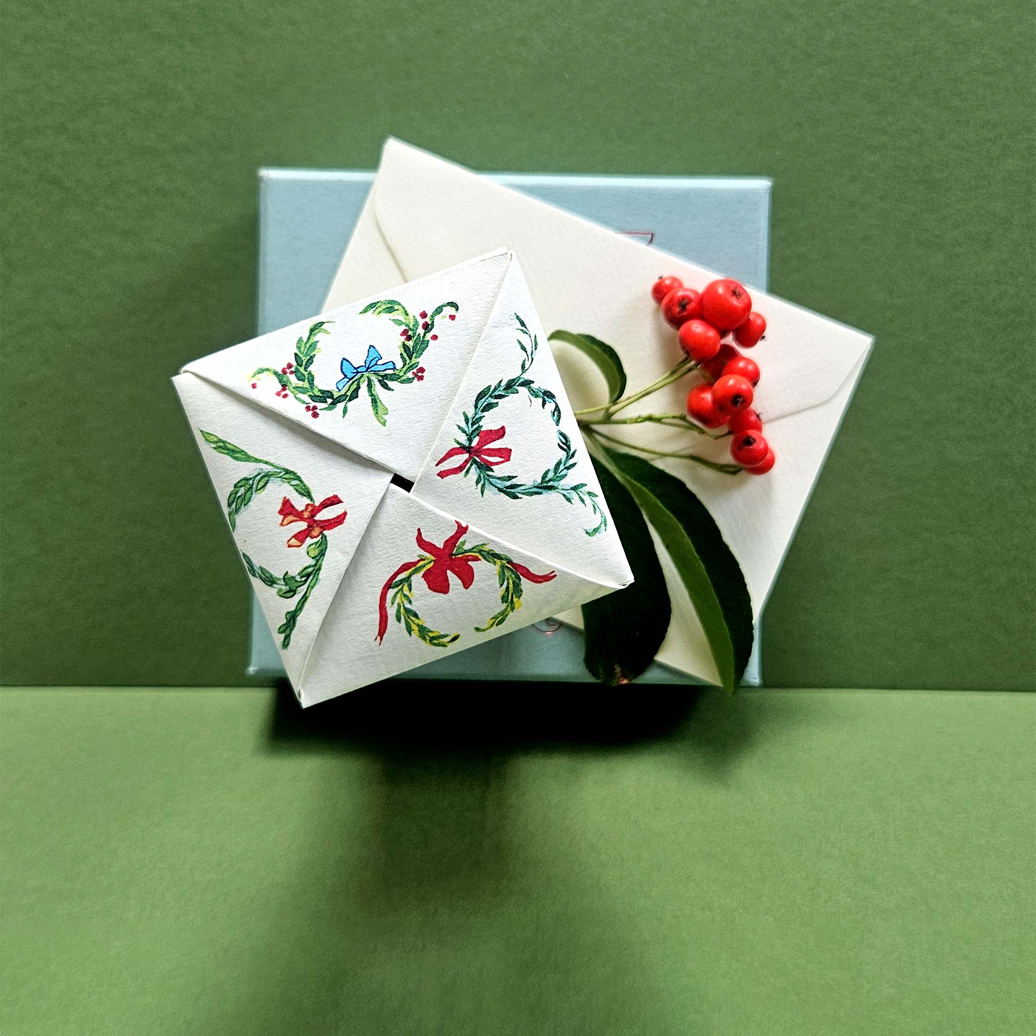 Decorative envelopes with floral designs on a green background