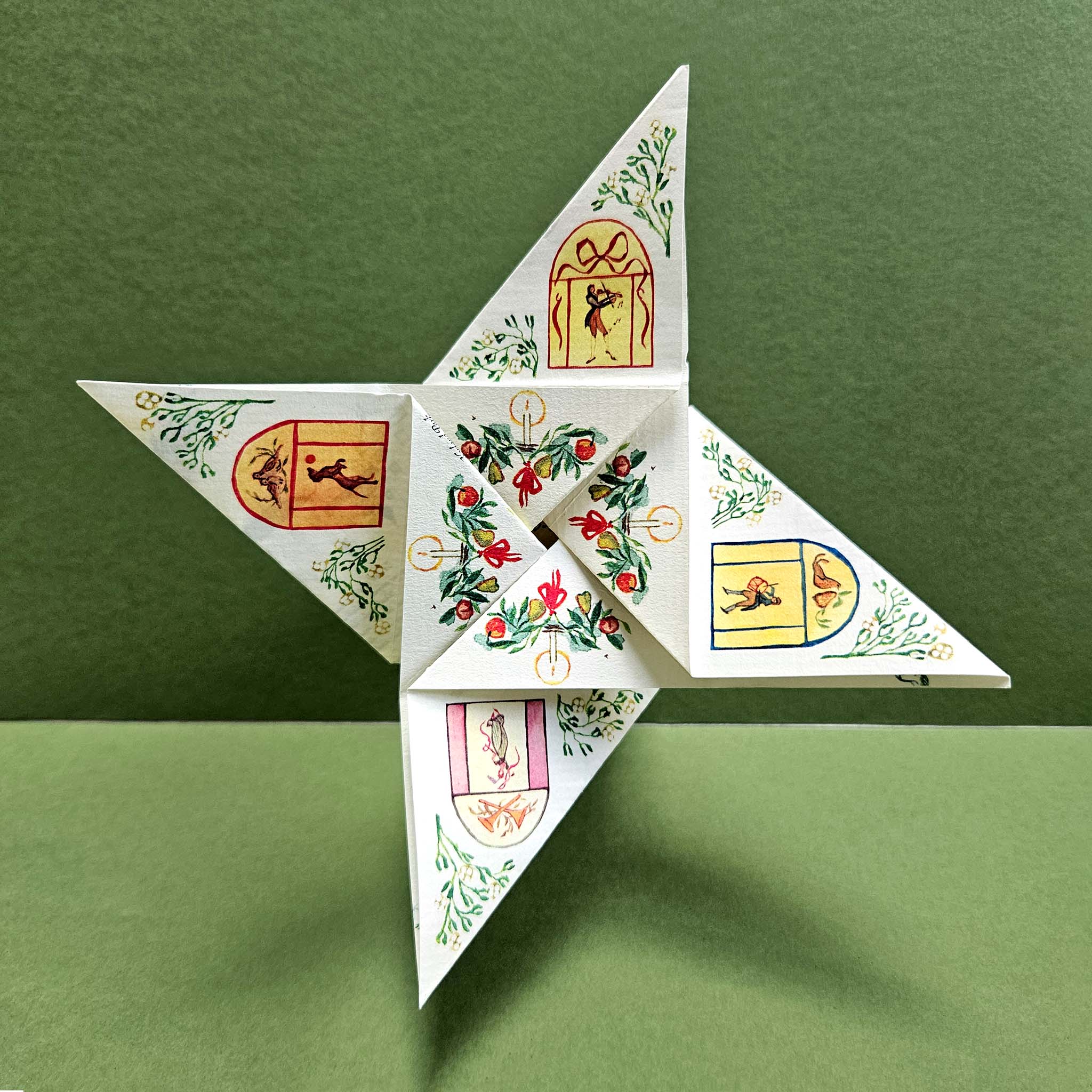 Decorative paper star with intricate designs on a green background