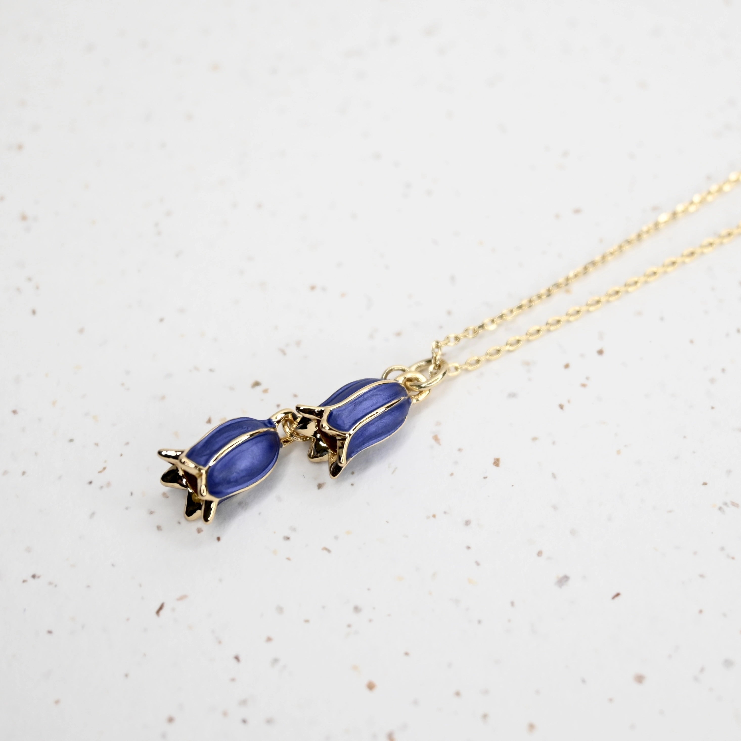 Closeup of Bluebell necklace in gold