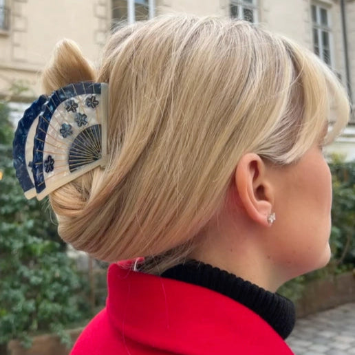 Hair Claw Clip in Blue blossom design . Styled as a fan, modeled on blonde hair