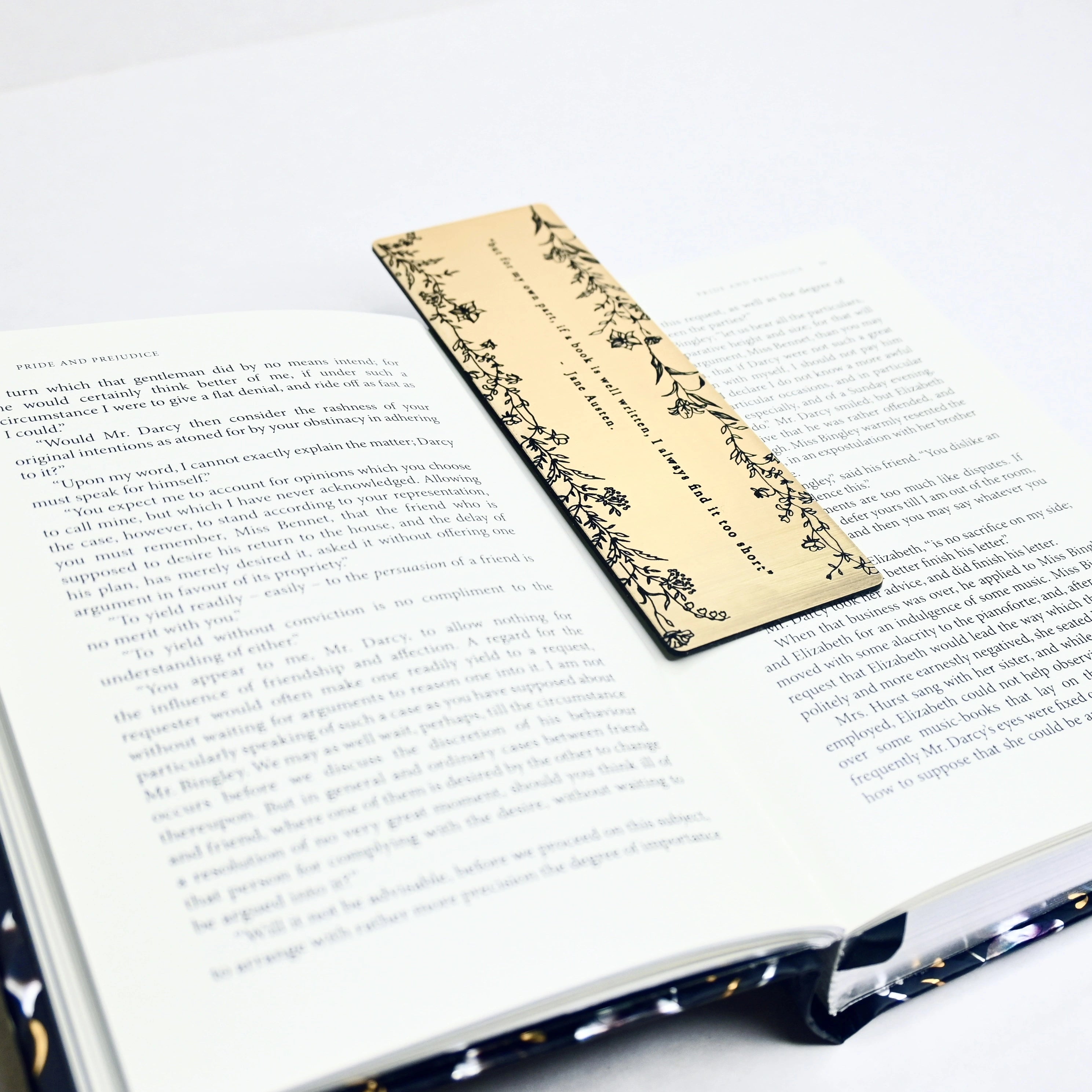 Bookmark with brushed gold acrylic featuring an engraved quote 'but for my own part, if a book is well written, I always find it too short' - Jane Austen.