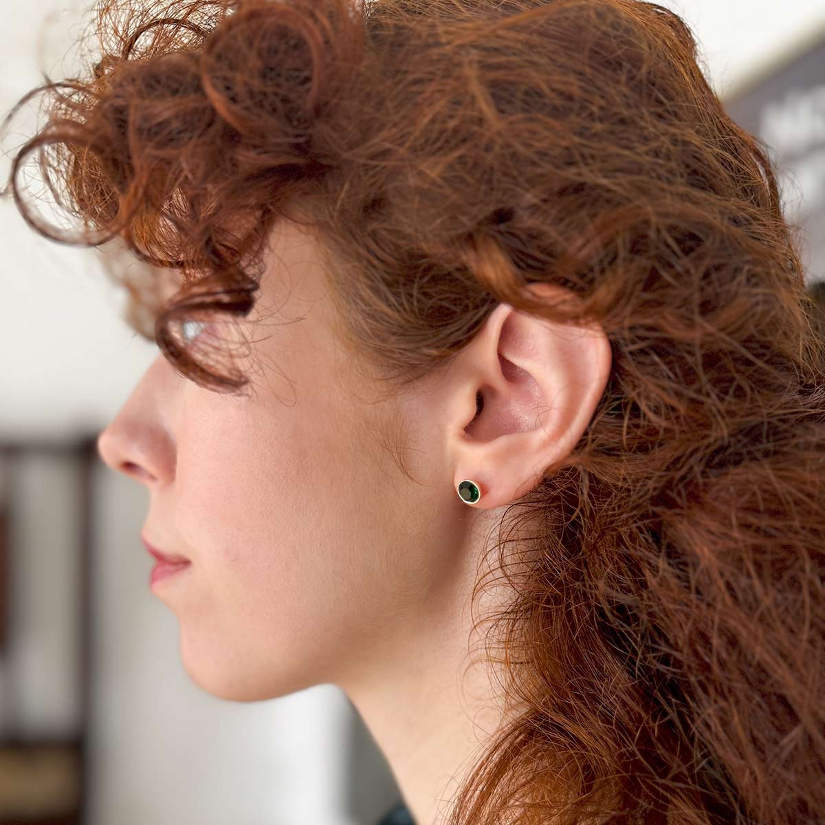 Side image of model wearing emerald style earring