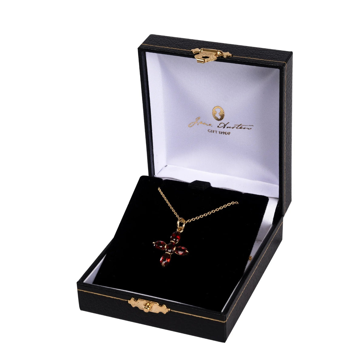 Gold necklace with red stones in a black jewelry box with 'Jane Austen' branding.