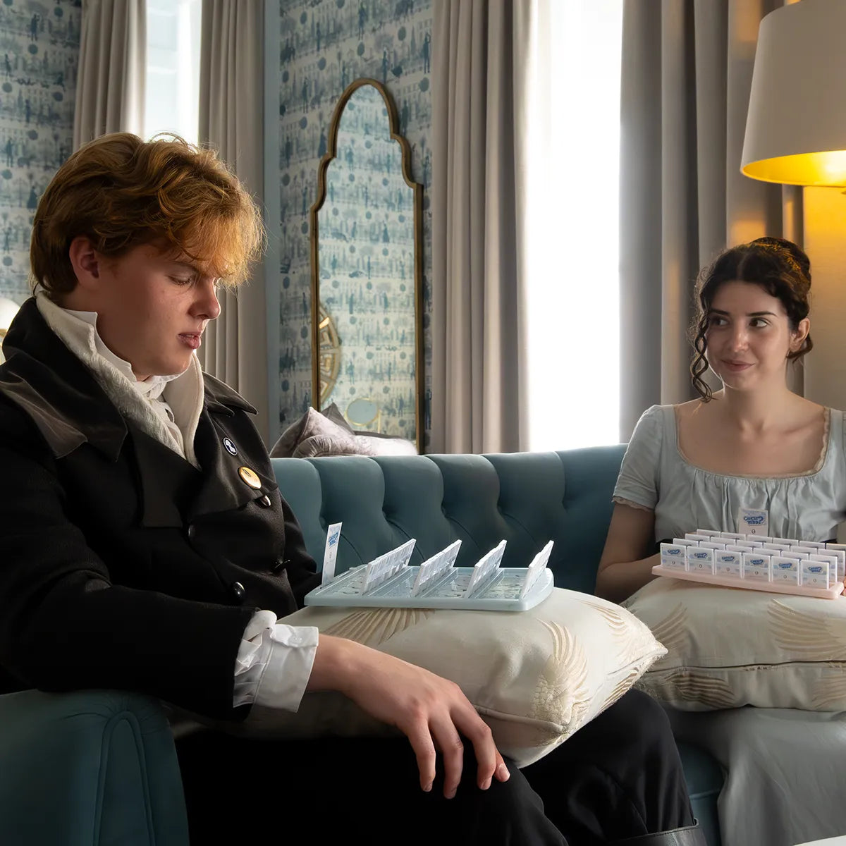 Two models enjoying a game of Jane Austen Guess Who in the Queensberry Hotel, Bath.