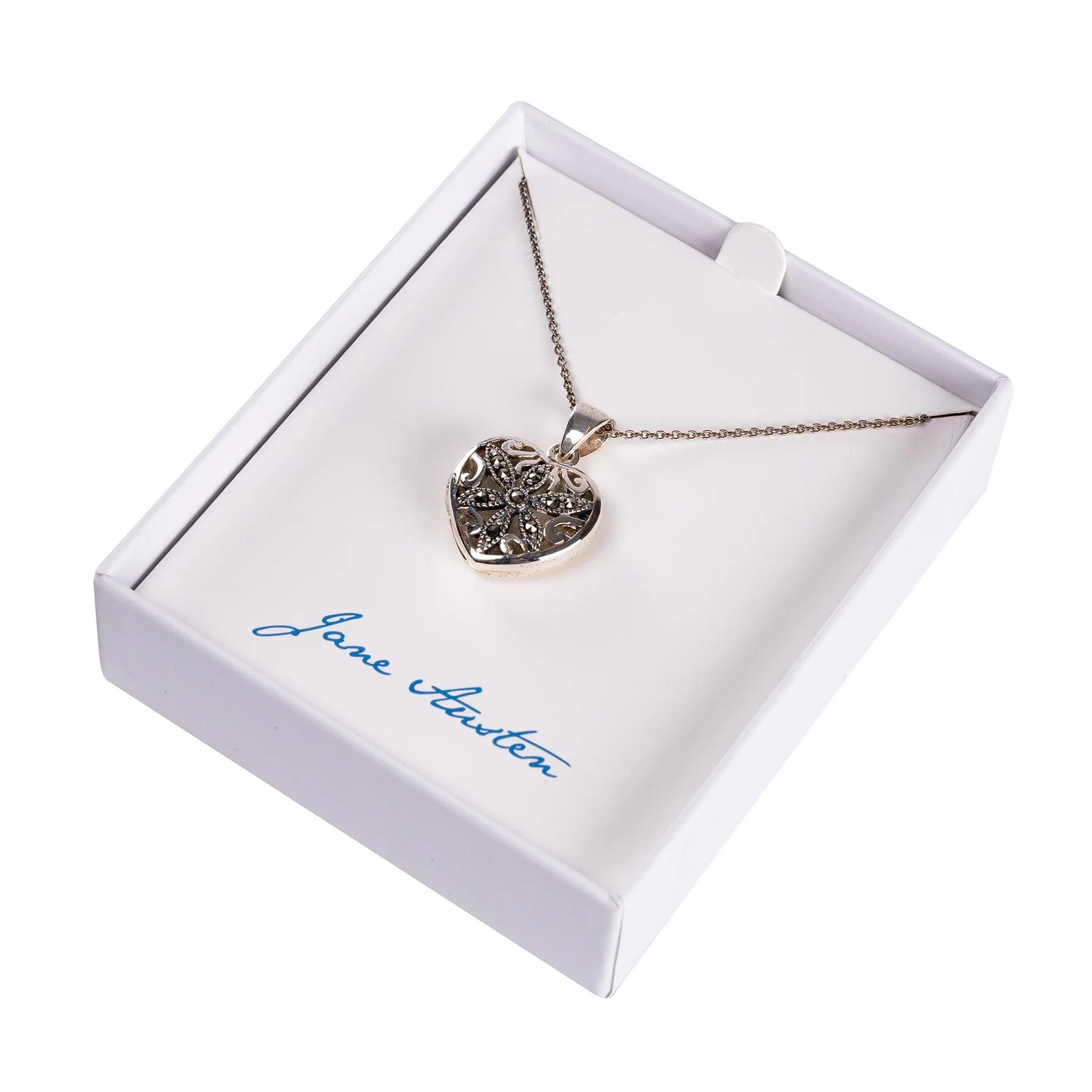 Silver and marcasite locket in a heart shape displayed in a white box