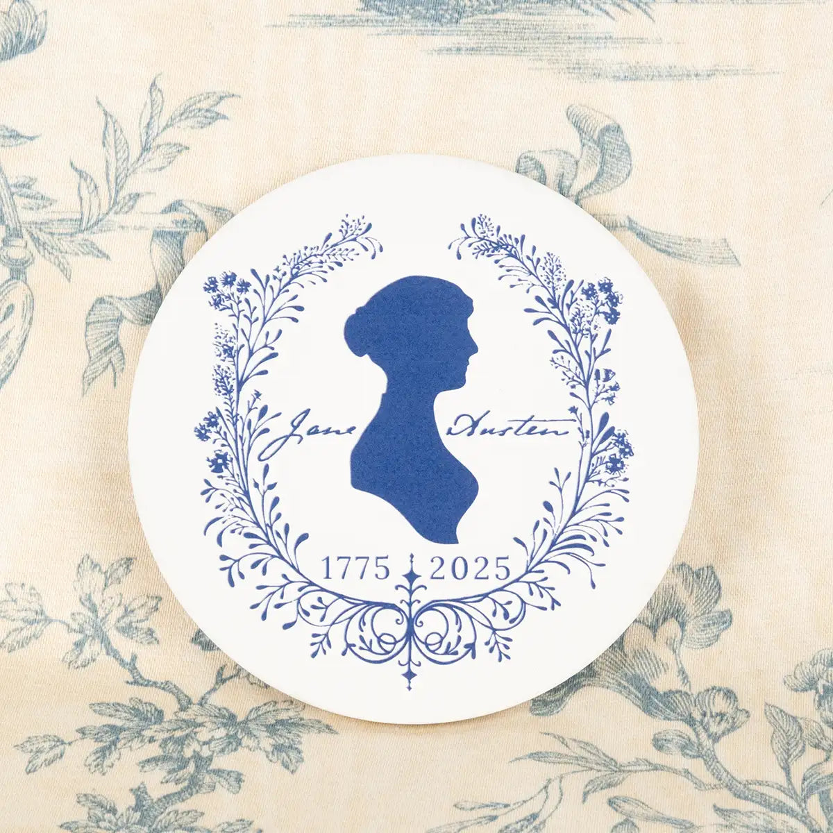 Coaster on patterned fabric background