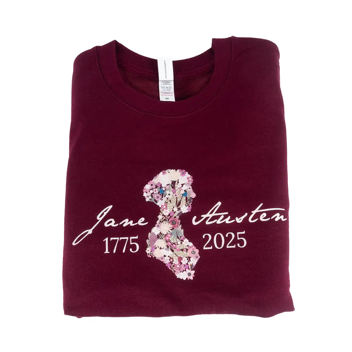 Maroon sweatshirt with floral design and text on a white background
