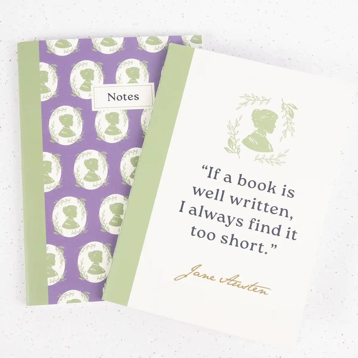 Two notebooks - one with a purple and green design, decorated with a Regency silhouette pattern, and a cream notebook with the Jane Austen quote "If a book is well written, I always find it too short".