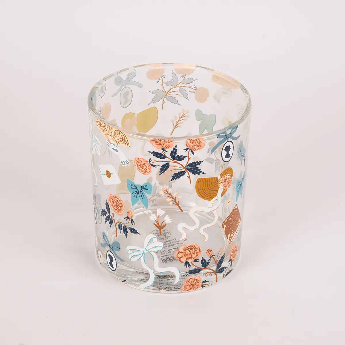 A shot from above of a Jane Austen themed glass tumbler against a white background