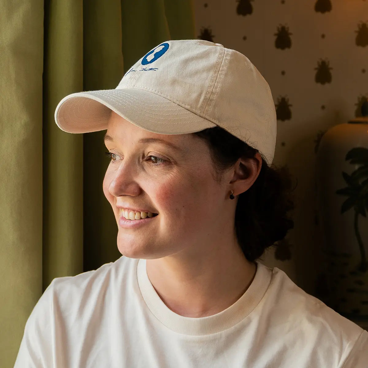 Woman wearing cream coloured Jane Austen cap with silhouette