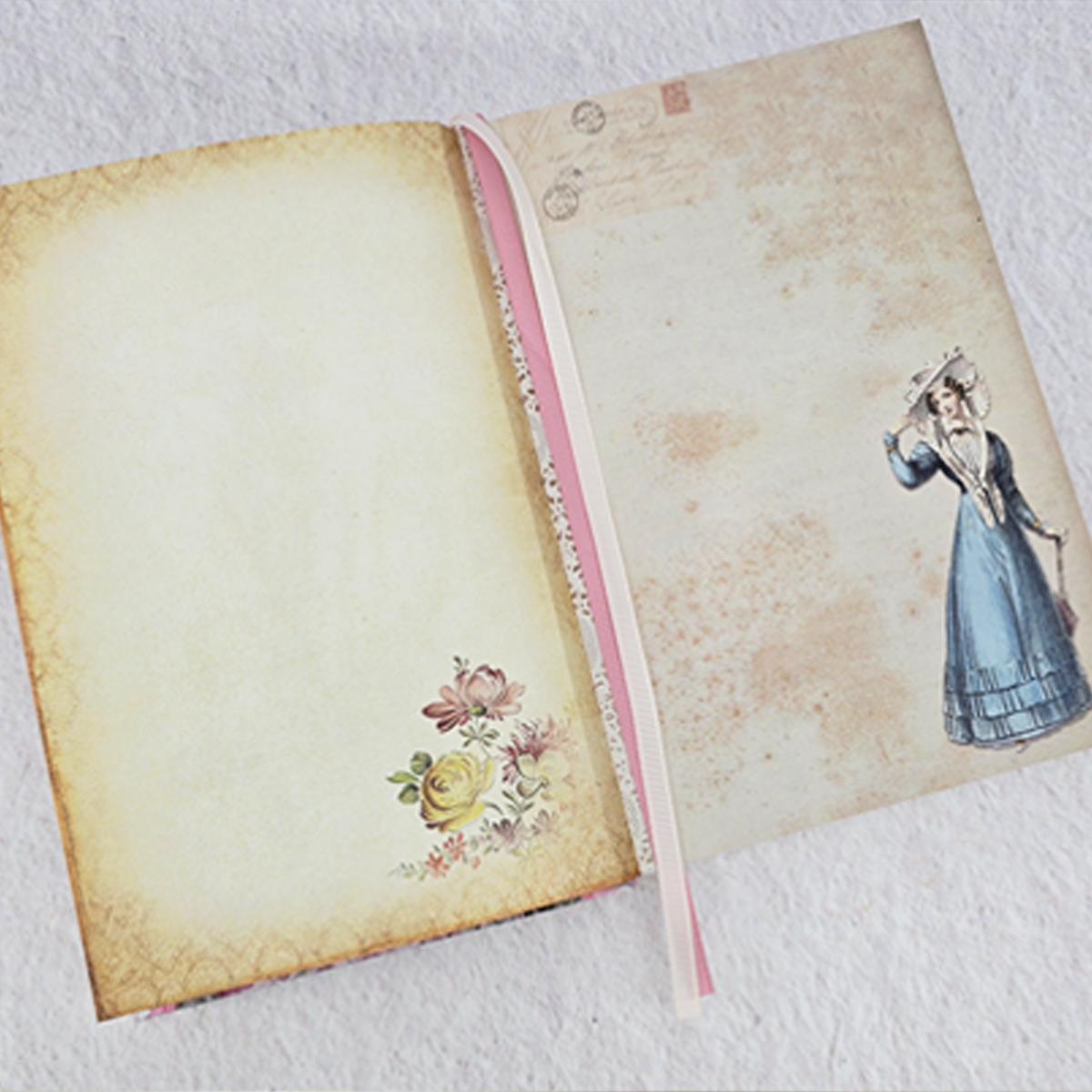 Journal open to two vintage illustrated pages on a pink, textured background.