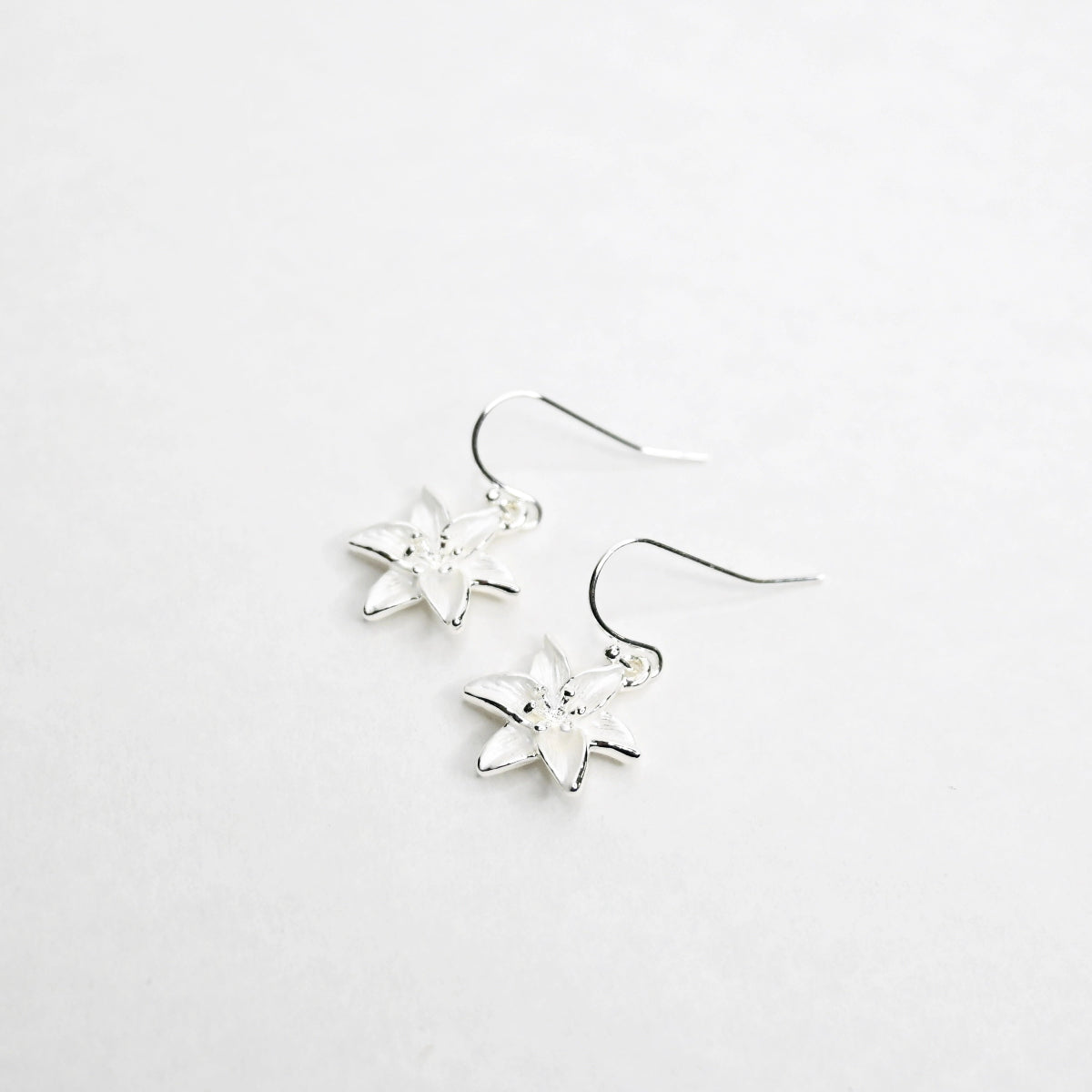 Lily hook earrings on a white background.