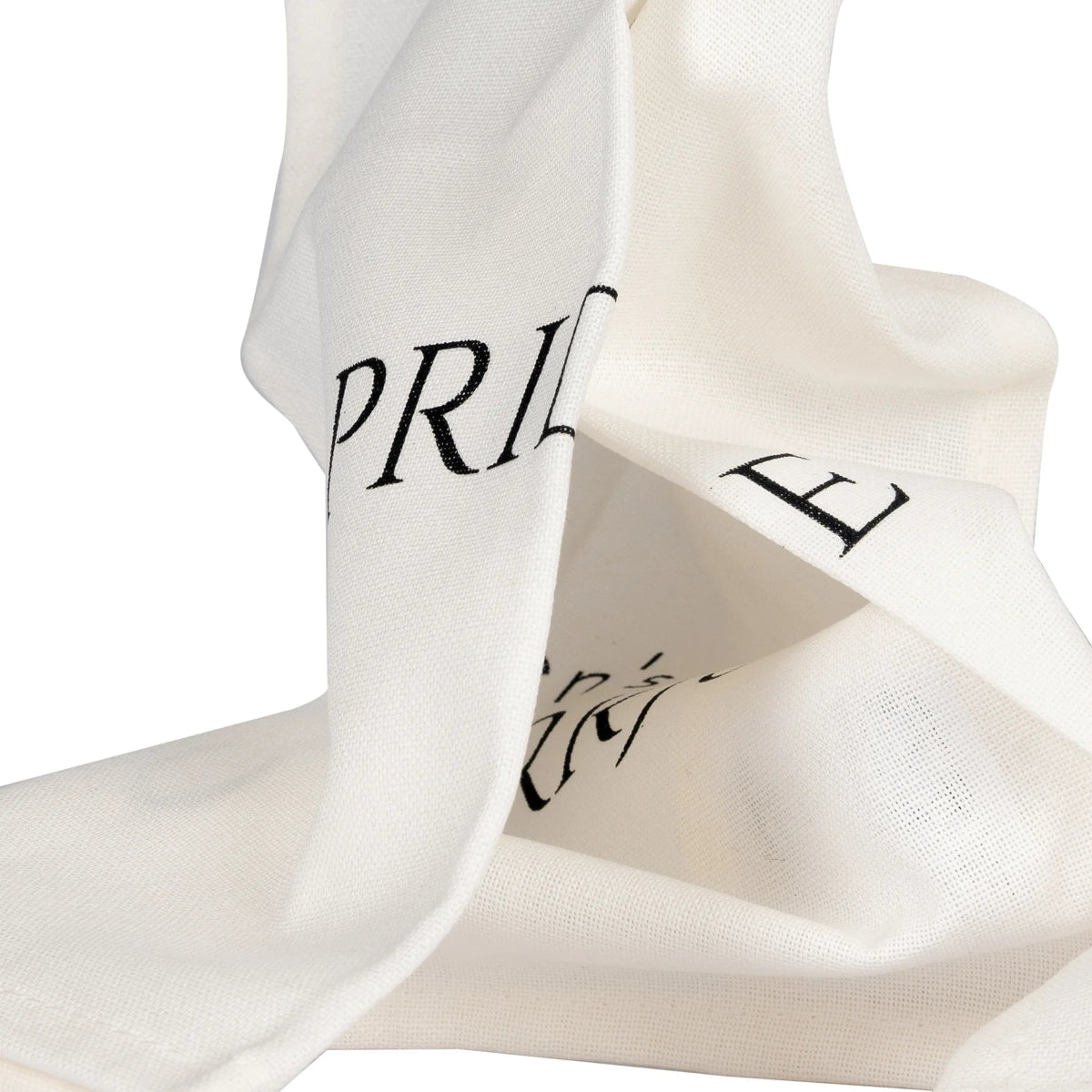 Folded white tea towel shows some of the letters of the words Pride and Puurjudice.