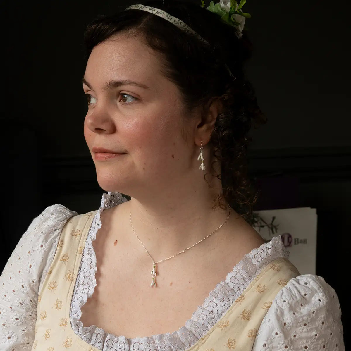 Model wearing snowdrop earrings and necklace