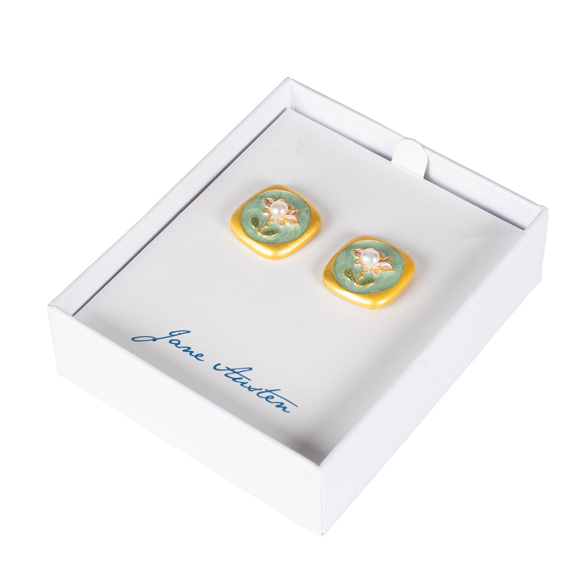 Two earrings inspired by regency era decor. Gold Borders with light green inner featuring a Flower and pearl as the centre of it. Featured in a White Jane Austen Jewellery Box
