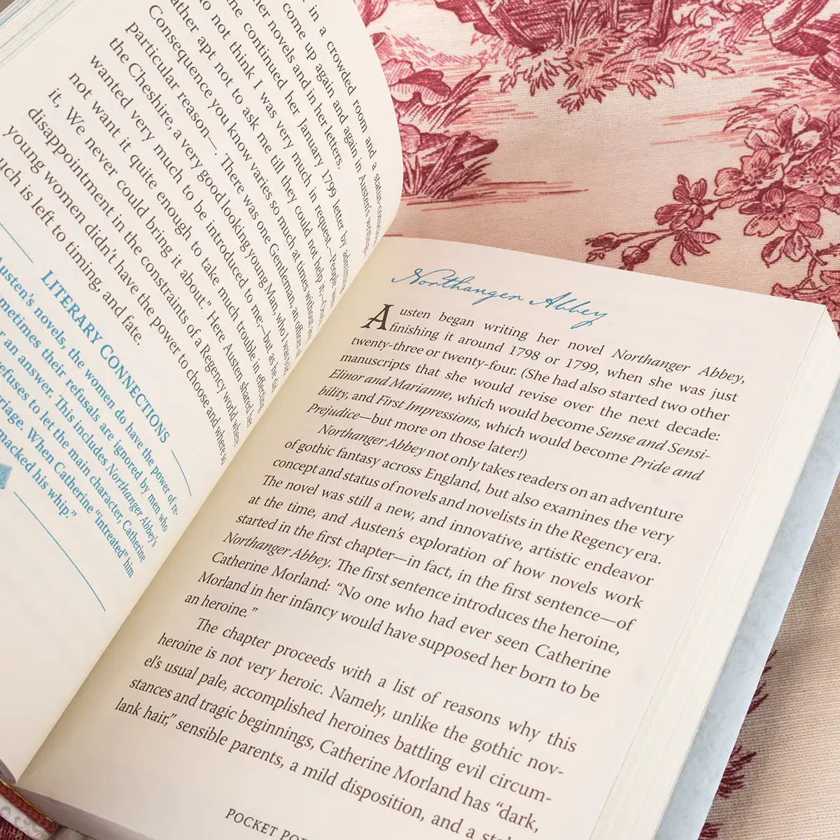 Open book with text on a floral-patterned fabric background