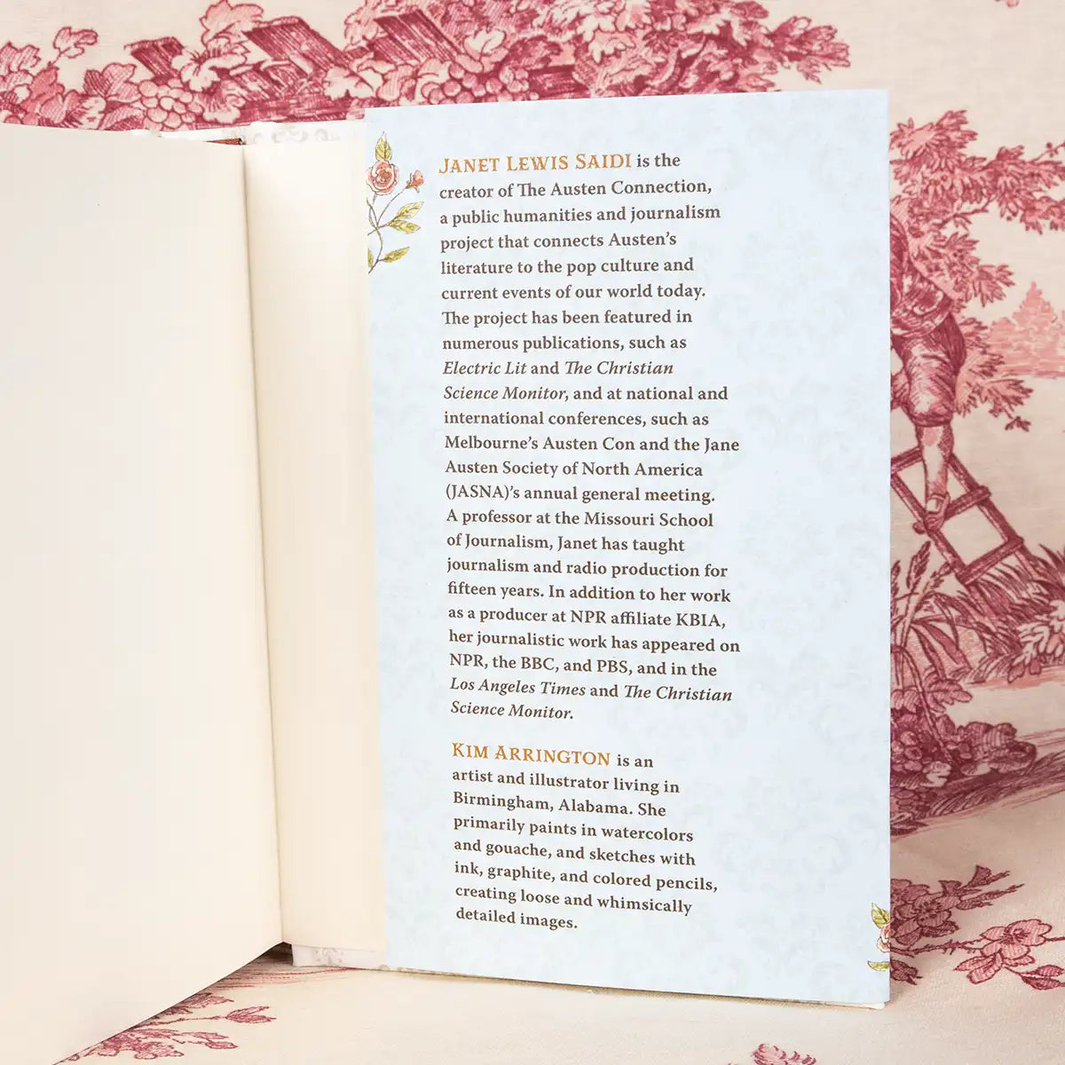 Open book with text on a decorative background