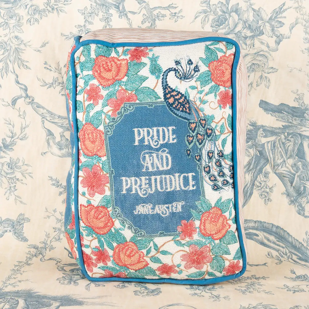 Pride and Prejudice cushion decorated with red roses and a peacock design