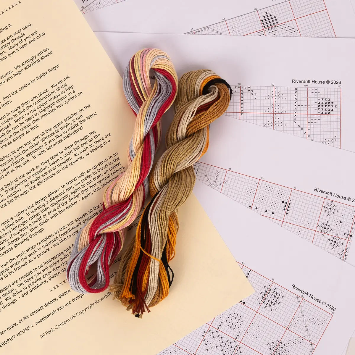 an assortment of items from the pemberley themed cross stitch kit