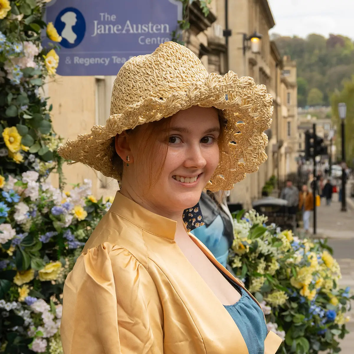 Woman on street wearing crochet bonnet and regency clothes