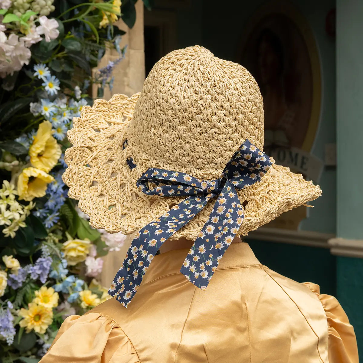 shot of the back of the bonnet featuring detail of daisy-patterned ribbon