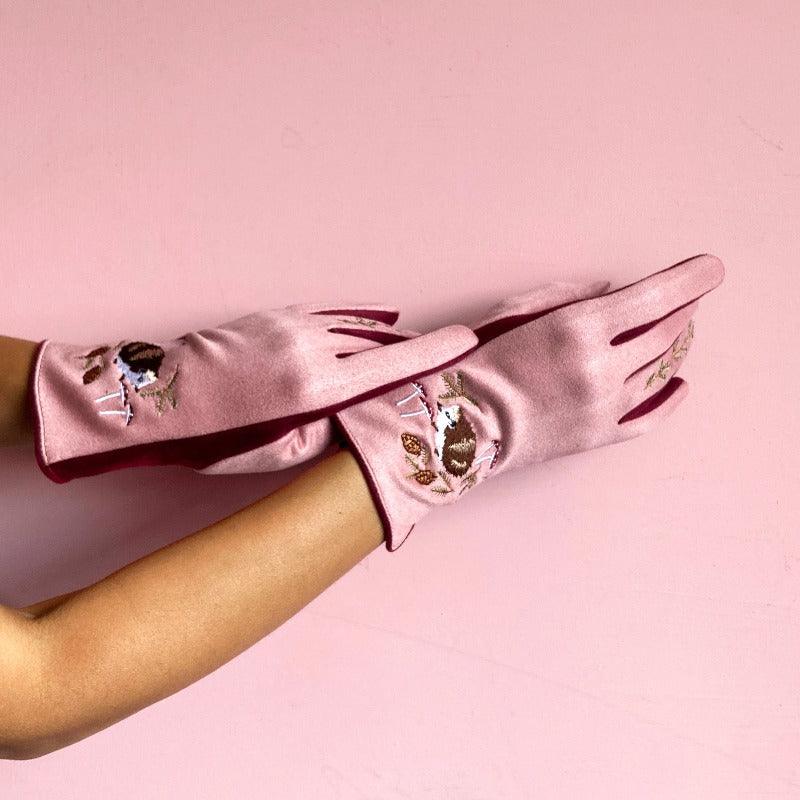 Pink-coloured gloves with an embroidered hedgehog and foliage details.