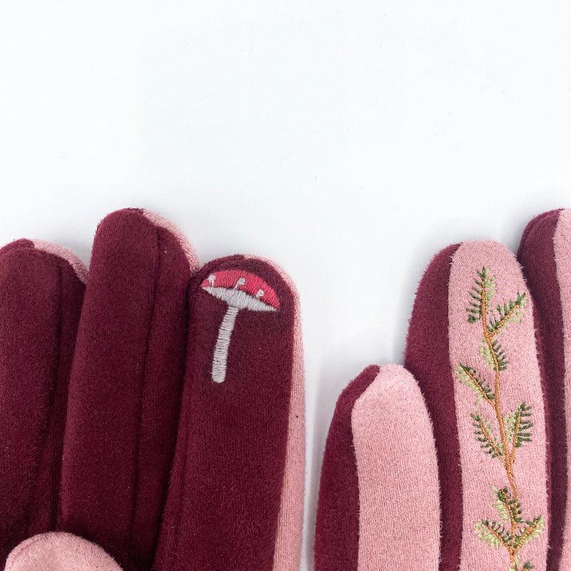 Pink-coloured gloves with an embroidered hedgehog and foliage details.