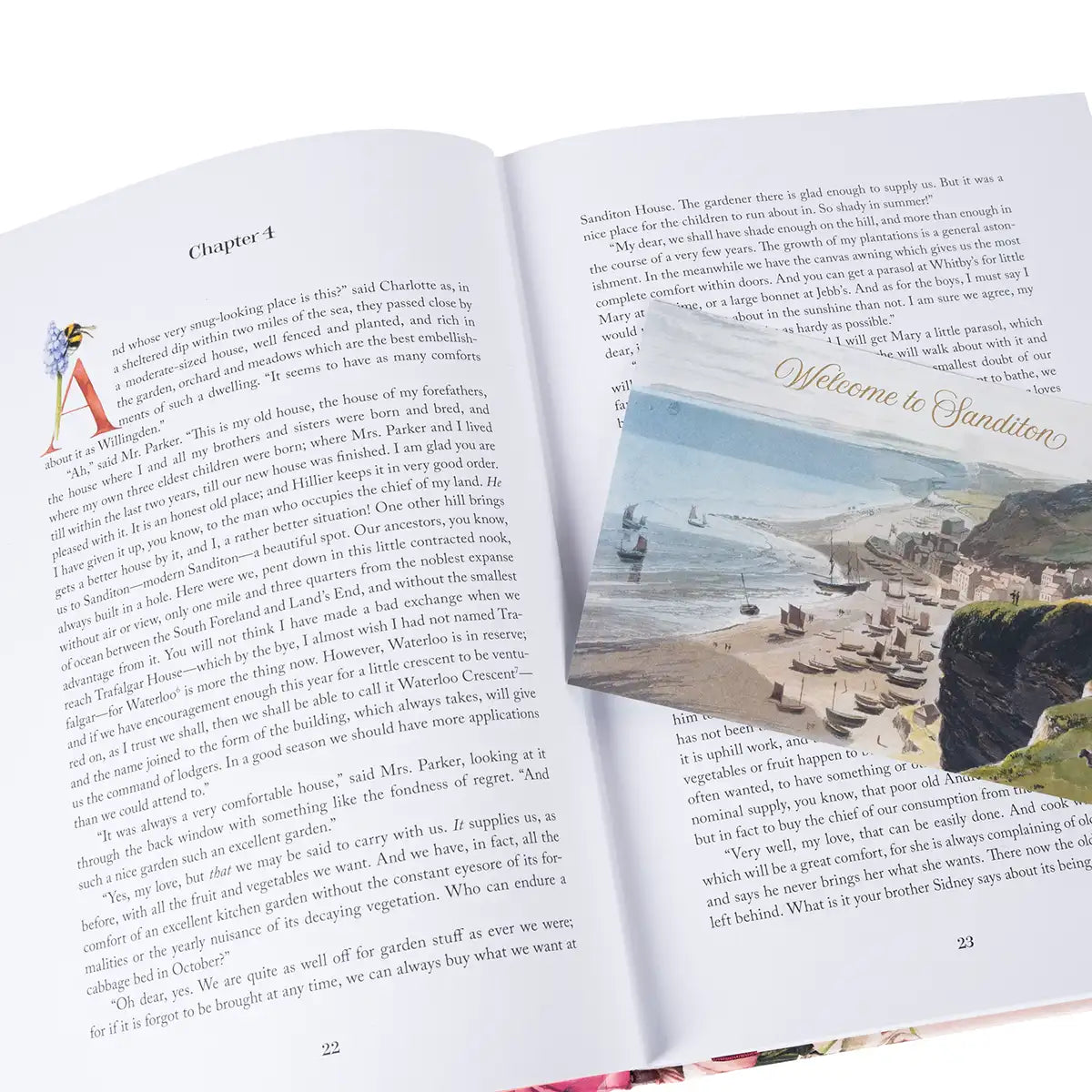 Open book with a scenic postcard overlay on a white background