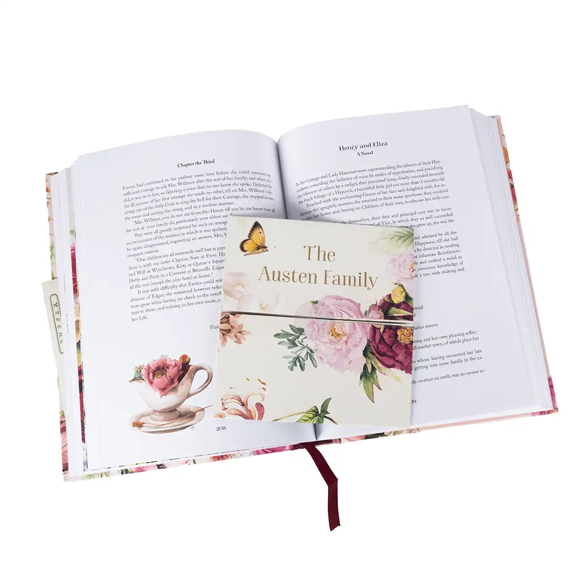 Open book with decorative bookmark featuring floral design and text 'The Austen Family'.
