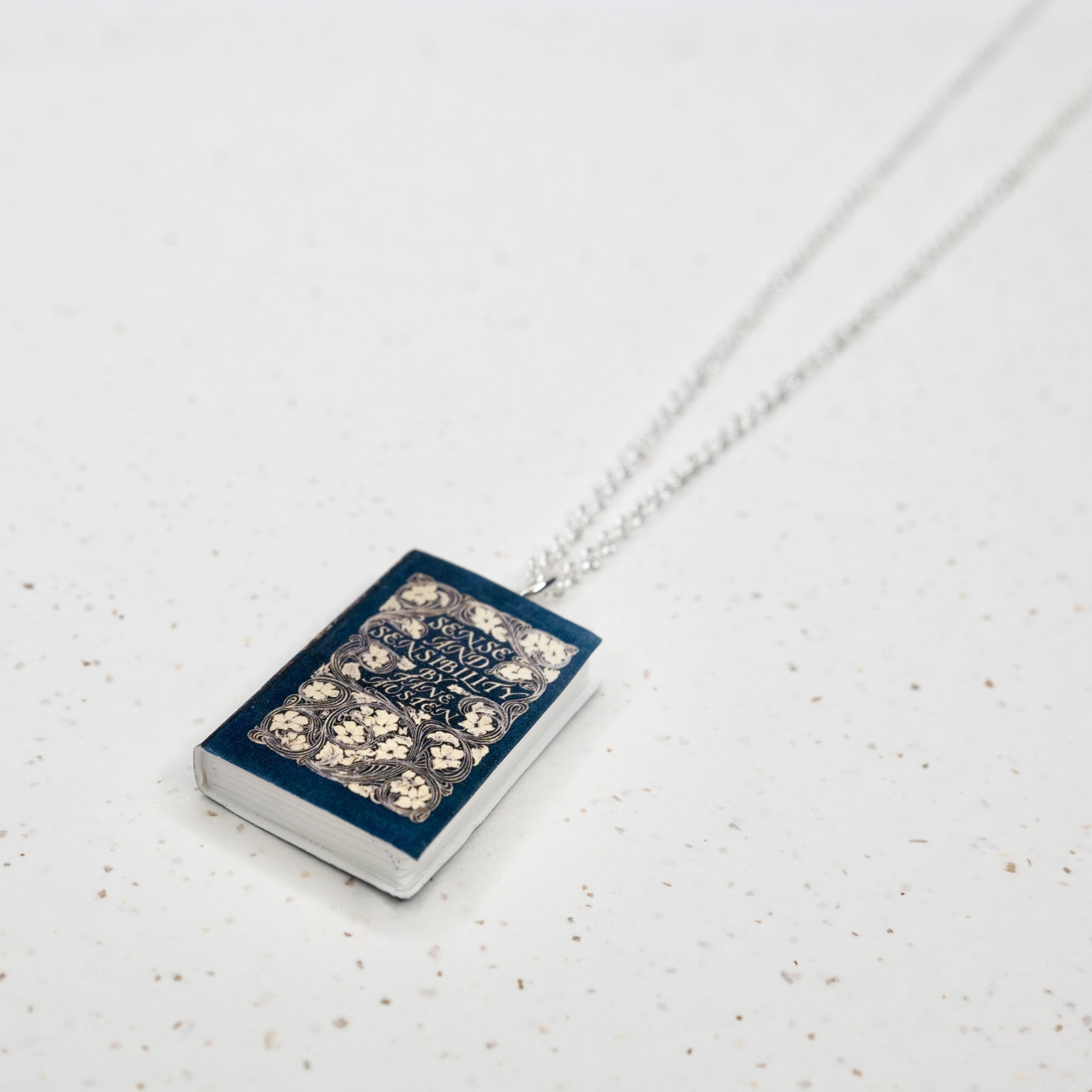 Sense & Sensibility Blue Book Cover Necklace in Silver- Closeup