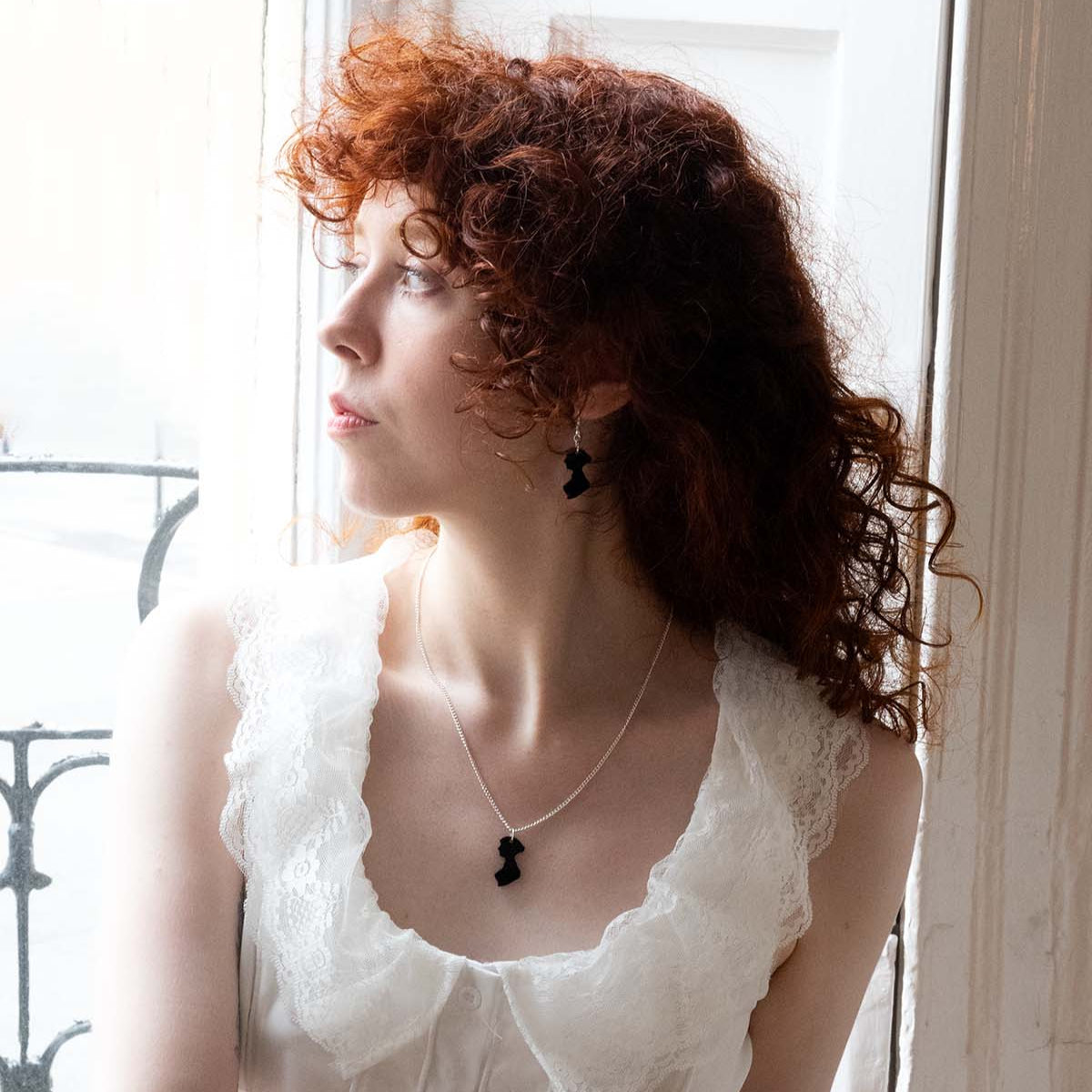 Black acrylic neckalce in the shape of Jane Austen's silhouette  on a womans neck