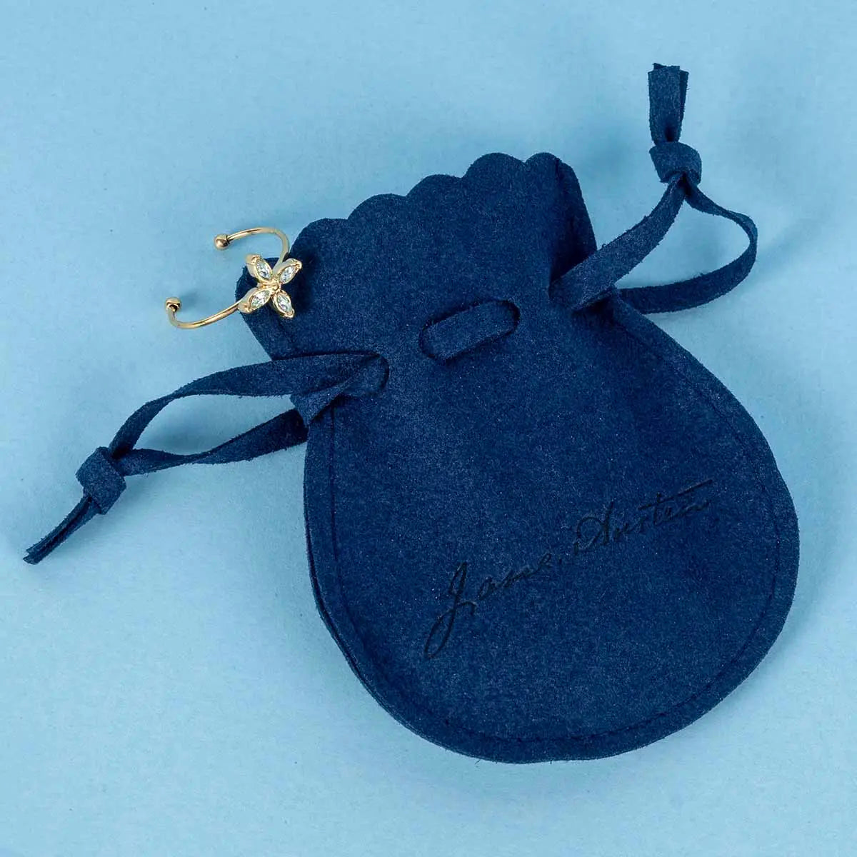 Anne Elliot aquamarine ring on a Blue felt drawstring bag