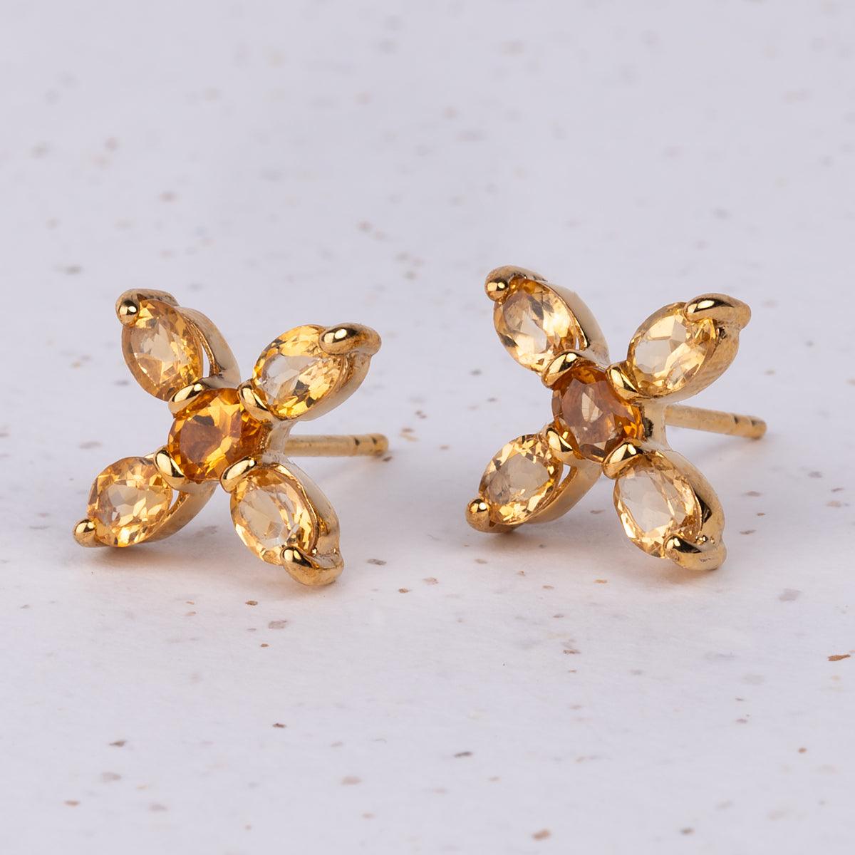 Close up of Jane Austen Topaz Cross earrings in Citrine and Gold