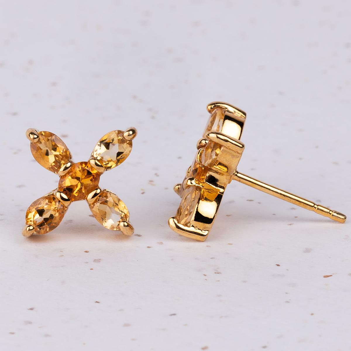 Closeup of Jane Austen Topaz Cross earrings in Citrine and Gold