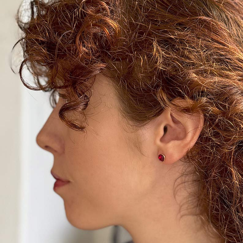 Side image of model wearing garnet style Elizabeth Bennet earring
