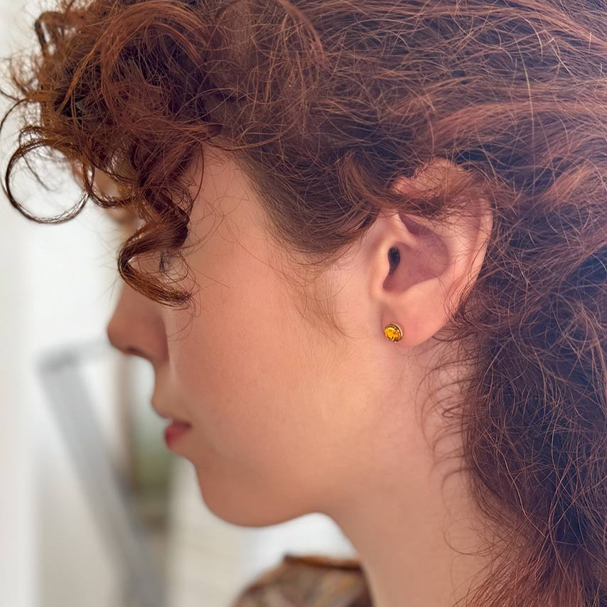 Side image of model wearing topaz style Fanny Price earring