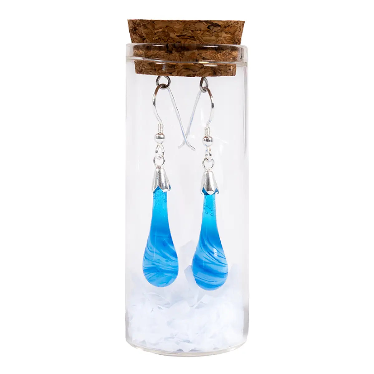 blue glass drop earrings with metal details in a glass tube vial with a cork against a white background