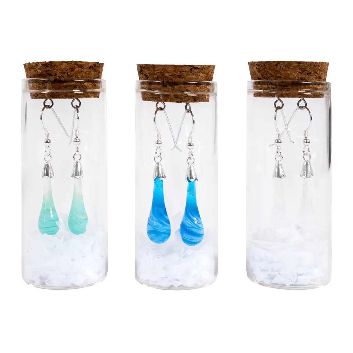 Mint, blue, and white glass drop earrings with silver details in glass vials with shredded tissue paper and corks with metal loops
