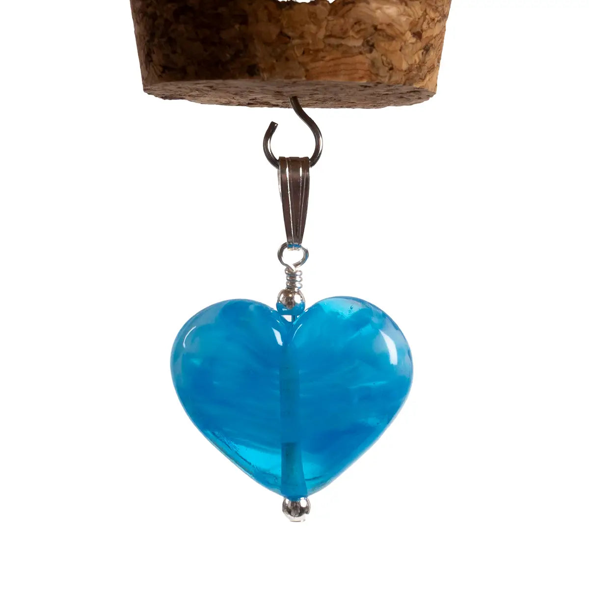 blue glass heart pendant close up against white background