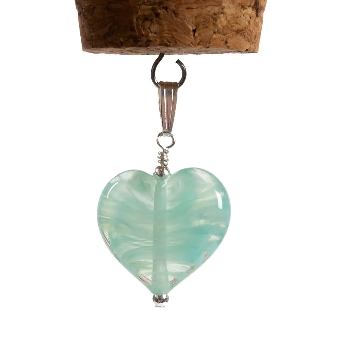 mint glass heart pendant close up against white background