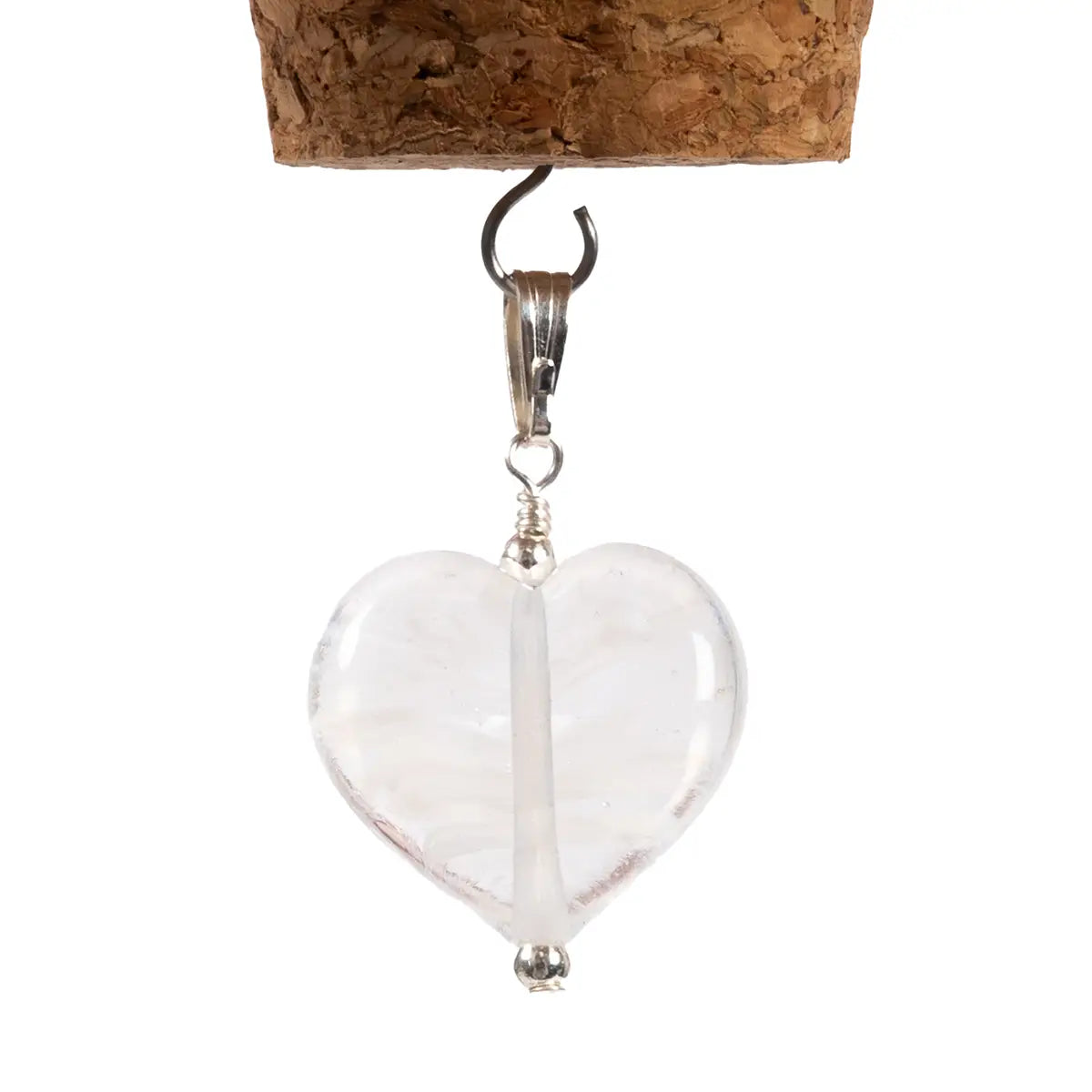 White glass heart pendant close up against white background