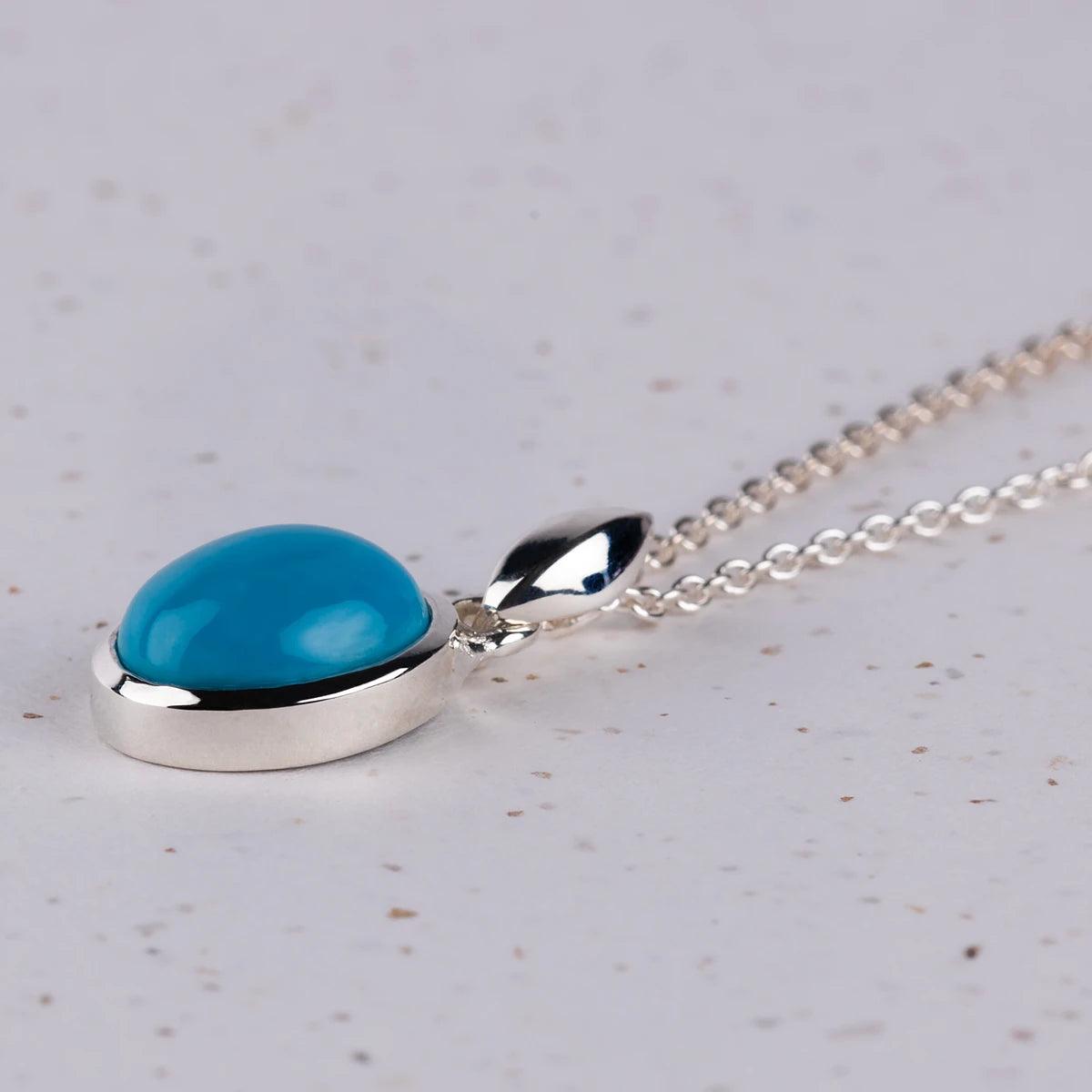 Closeup of Turquoise Pendant on a silver Necklace