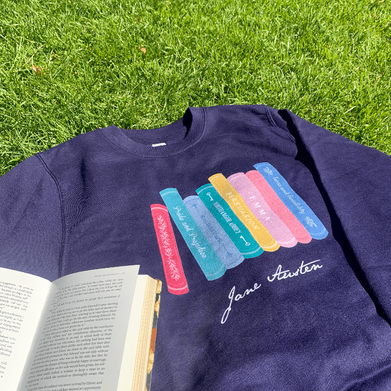 Made from a soft blend of 80% cotton and 20% polyester, the adorable design illustrates all of Jane Austen completed novels, from Pride & Prejudice to Persuasion. Available in Navy Blue, this Jane Austen Sweater makes a thoughtful gift for any lover of Jane Austen's novels and characters.