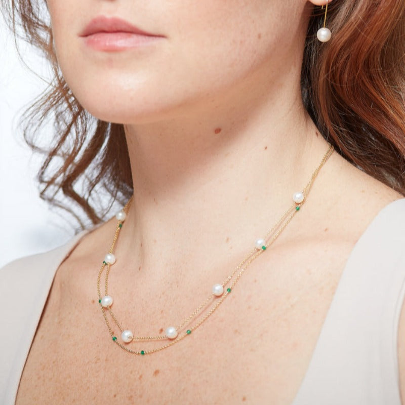 This captivating necklace is meticulously designed for lovers of Jane Austen, Bridgerton, and all things timeless. Crafted with utmost care and attention to detail, this necklace is adorned with round cultured freshwater pearls and mesmerising cut emerald jewel stones.