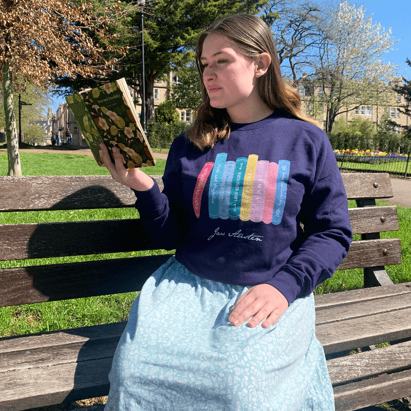 Made from a soft blend of 80% cotton and 20% polyester, the adorable design illustrates all of Jane Austen completed novels, from Pride & Prejudice to Persuasion. Available in Navy Blue, this Jane Austen Sweater makes a thoughtful gift for any lover of Jane Austen's novels and characters.