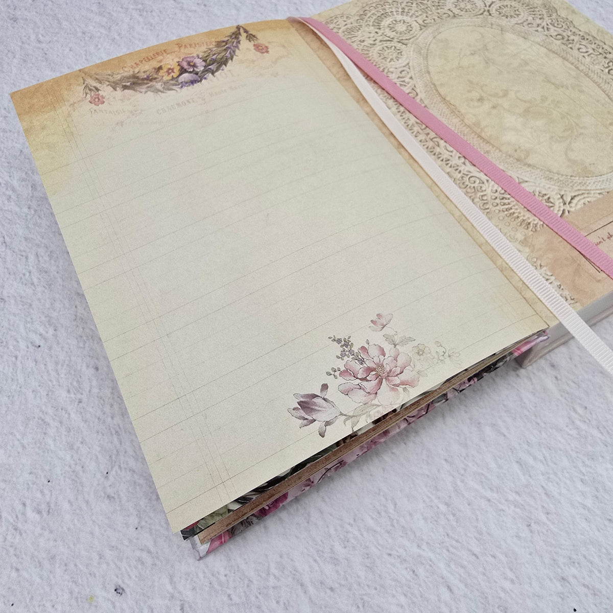 Decorative notebook with floral designs on a textured surface
