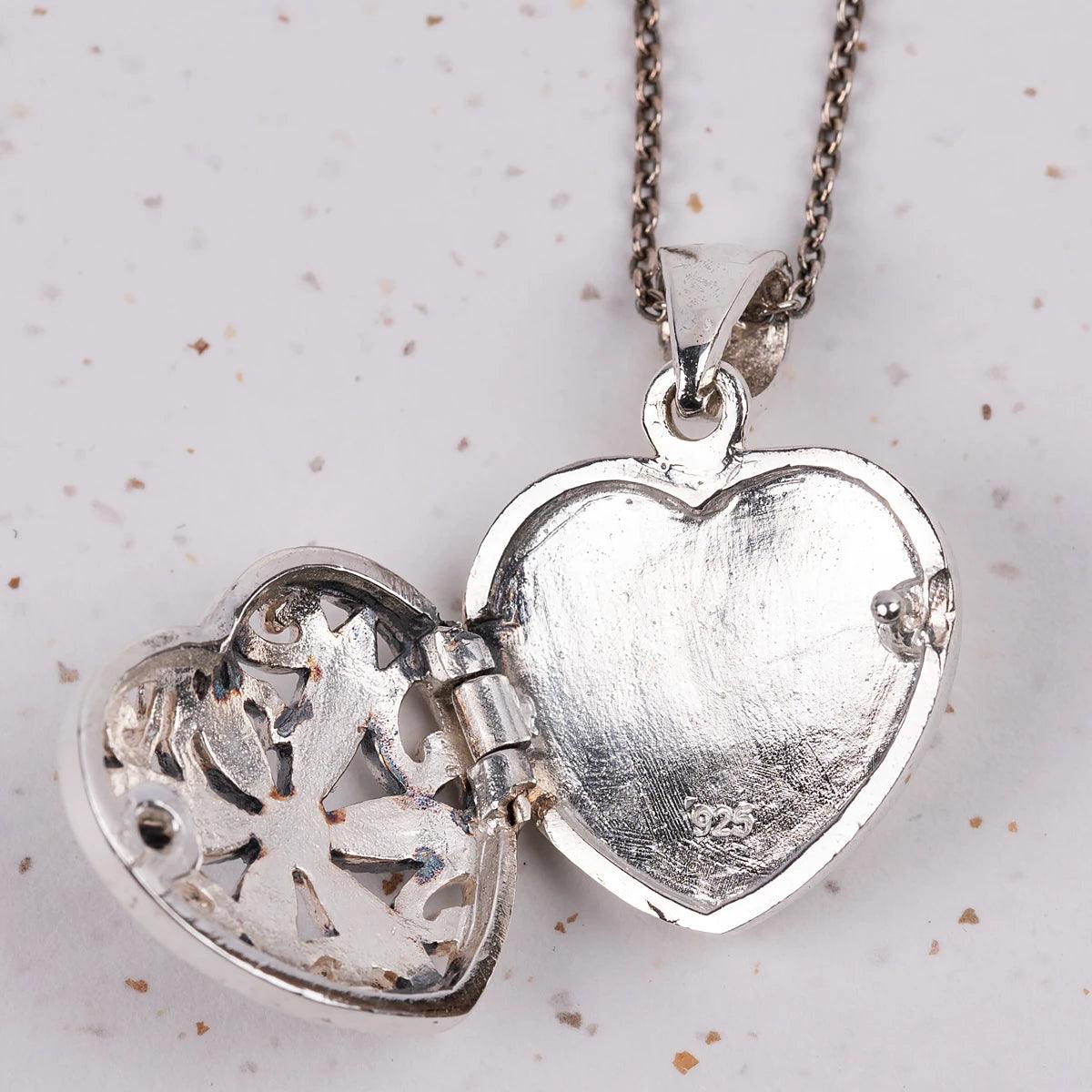 Closeup of a heart shaped locket that is open