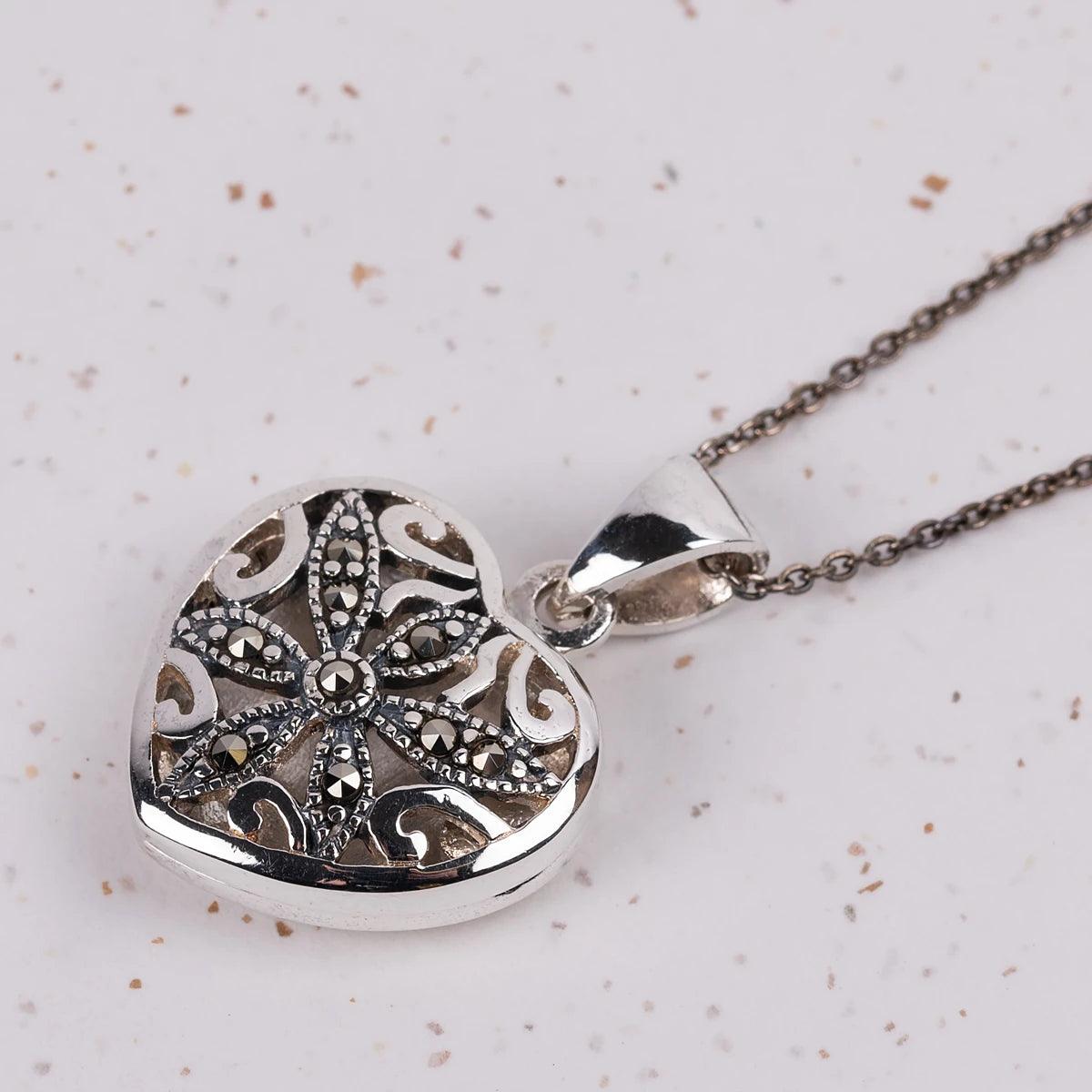 Closeup of a Silver and marcasite locket in a heart shape on a necklace
